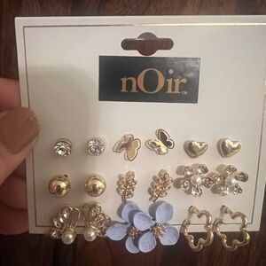 NOir nine pairs of gold tone, pierced earrings.  New on card.